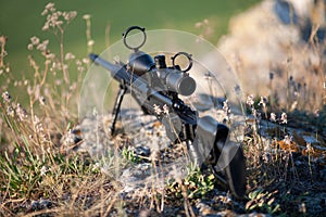Sniper rifle with bipod on combat position photo