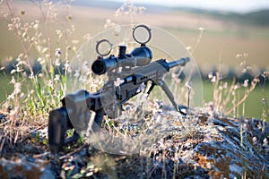Sniper rifle with bipod on combat position photo
