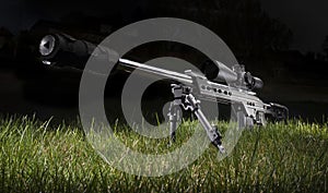 Sniper rifle with silencer and scope in the dark