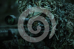 Sniper wearing ghillie suit