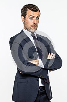 Snob middle aged businessman with arms crossed standing with arrogance