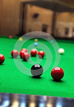 Snooker balls on green game table closeup