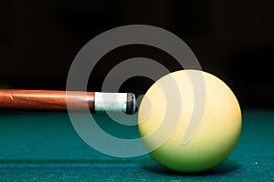 Snooker club and white ball in a billiard table