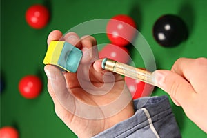 Snooker cue, chalk and hands