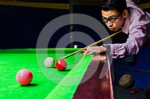 Snooker player placing the cue ball for a shot