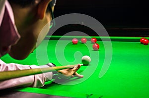 Snooker player placing the cue ball for a shot