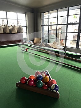 snooker table in games room with baskets and hat