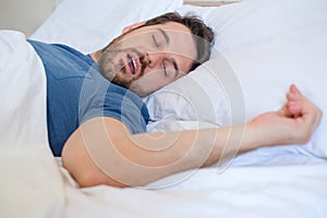 Snore problem concept.Man in bed snoring and sleeping
