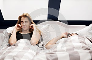 Snoring man in bed with wife