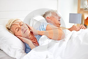 Snoring, problem and woman with frustrated with noise, sound or husband sleeping in bed with wife. Elderly, couple and