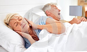 Snoring, problem and woman with frustrated with noise, sound or husband sleeping in bed with wife. Elderly, couple and