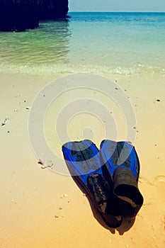 Snorkel gear on a beach. Vintage toned background.
