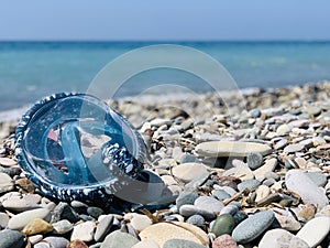 Snorkel gear by the sea. swimming mask scuby on the pebble beach