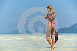Snorkel girl with scuba mask and snorkeling fins relaxing on Thailand beach travel summer vacation. Ocean watersport tropical fun