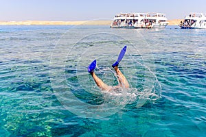 Snorkeler diving below the sea