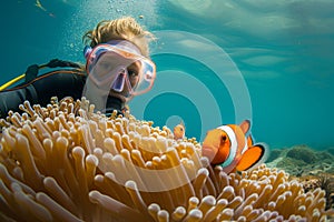 snorkeler with fullface mask observing clownfish in anemone