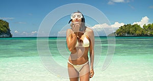 Snorkeling, beach and woman blow kiss for outdoor freedom, summer wellness and affection on tropical island. Ocean, sea