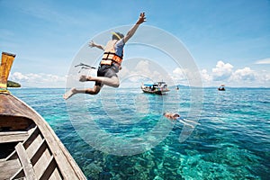 Snorkeling divers jump in the water