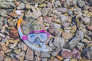 Snorkeling Mask Dry Snorkel Water Sports Gear on Stone Beach Coastline Sea Relax Summer Vacation Holiday Concept Tone