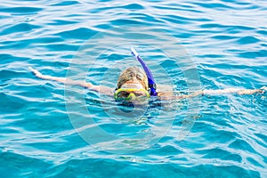 Snorkeling mask on woman face portrait swimming water activities life style passion concept photography with blue water outdoor