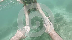 Snorkeling romantic couple hold hand in han underwater sea