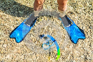 Snorkeling set and pebbly beach