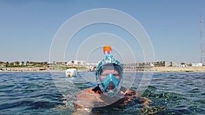 snorkeling. Swimming. diving. happy snorkler. a man, in a snorkeling mask, is exploring underwater coral reef with