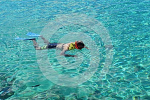 Snorkeling on top of a crystal clear blue water