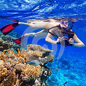 Snorkeling in the tropical water with camera