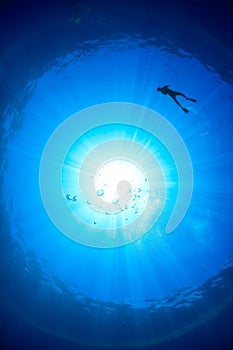 Snorkeller Silhouette and sunburst