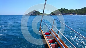 Snorkelling ladder on back of boat in blue sea