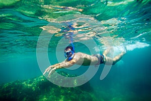 Snorkling man swim underwater photo