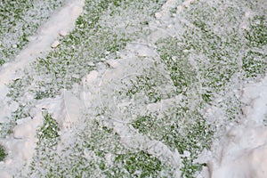 Snow on artificial green lawn on field in football photo