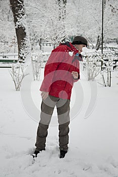 Young man dodging a snowball