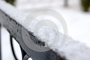 Snow on the black wrought iron railing