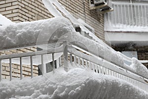 Snow blocks on top of balcony railing