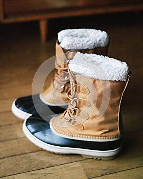 Snow boots on wood floor,close up photo