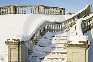 A snow-bound stone stair is in a winter park