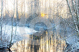 Snow by a brook at dusk