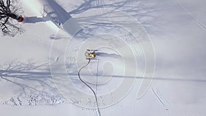 Snow cannon in action on mountain at ski resort aerial view. Drone view snow cannon working on ski mountain.