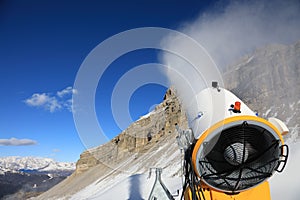 Snow cannon against the blue sky