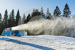 Snow cannon during the production of artificial snow.