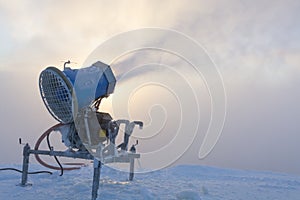 Snow cannon in snow cloud