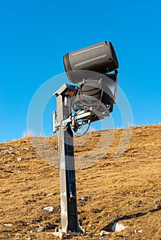 Snow Cannon or Snowmaking System on a Brown Ski Slope - Italy