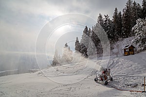 Snow cannon at the top of mountain at winter