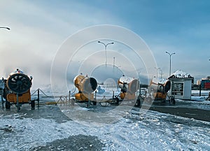 Snow cannons spray artificial snow crystals. Artificial snow production system. Cars make snow