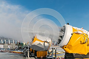 Snow cannons spray artificial snow crystals. Production of artificial snow. Snow guns. Cars make snow