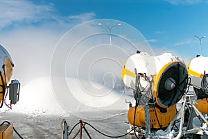 Snow cannons spray artificial snow crystals. Production of artificial snow. Snow guns. Cars make snow