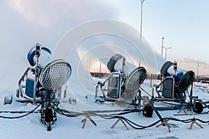 The snow cannons sprays artificial snow crystals. Cars make snow. Artificial snow system. Snow guns