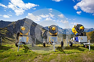 Snow cannons waiting for the winter action in the European alps at the valley Kleinwalsertal